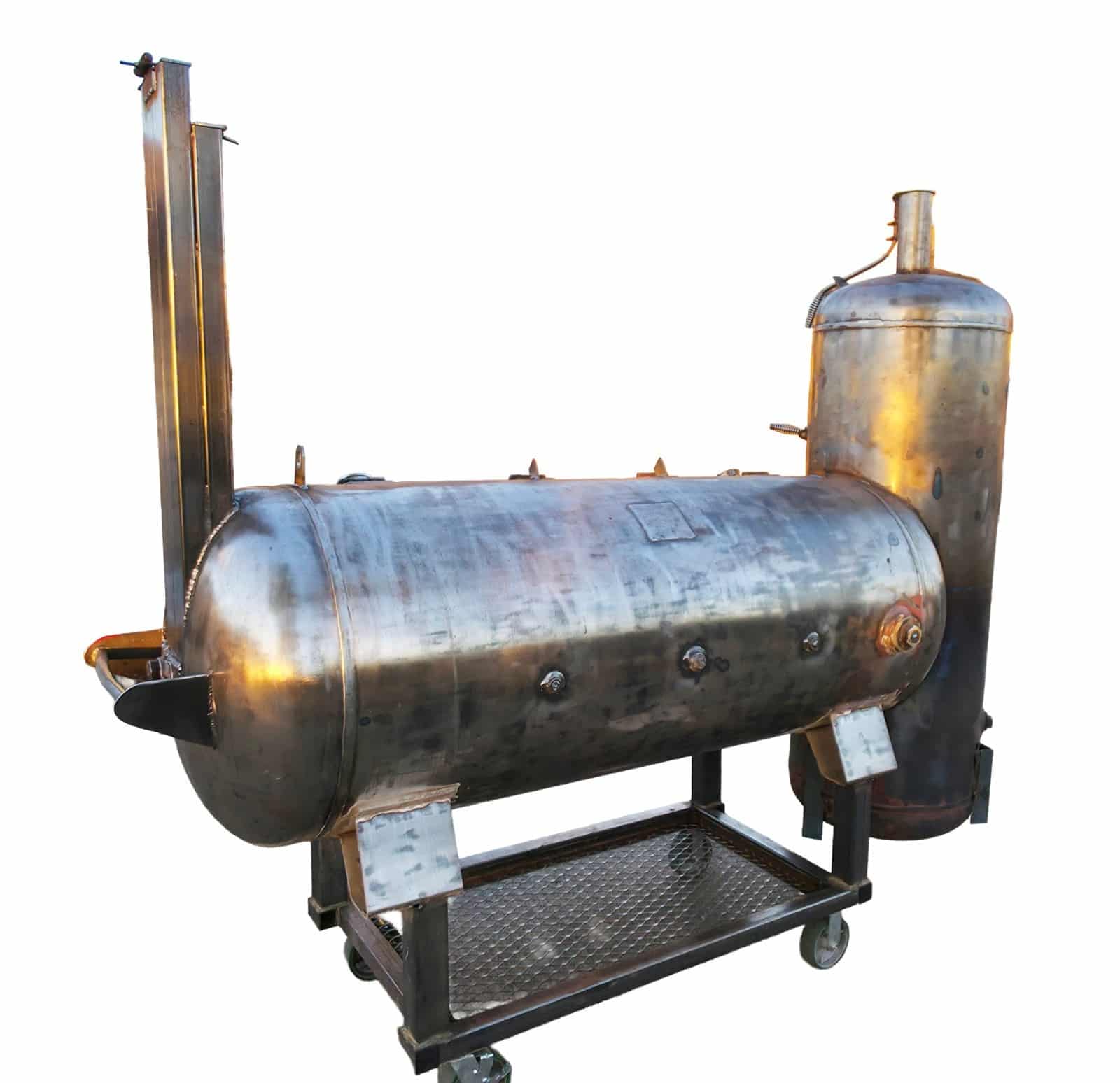Rear three-quarter view of the hybrid offset smoker showing the tall rectangular end stack on the horizontal chamber, the round tower stack, the welded cart with expanded-metal wood rack and the bare brushed steel finish